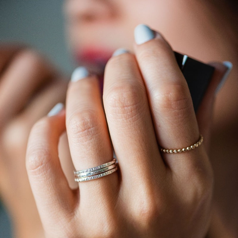 textured stacking bands on hand