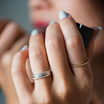 textured stacking bands on hand